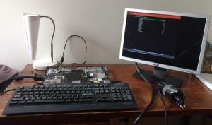 Stripped-down laptop attached to a keyboard and monitor.