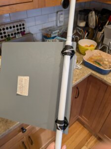 Back of tension-rod mounted mirror